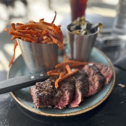 Thompson & Co - Grilled steak with sweet potato fries and collard greens