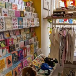 Secret Planet Print Shop - Card section with bags and tea towels, all by local artists