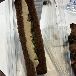 a sandwich in a plastic container a sandwich in a plastic container