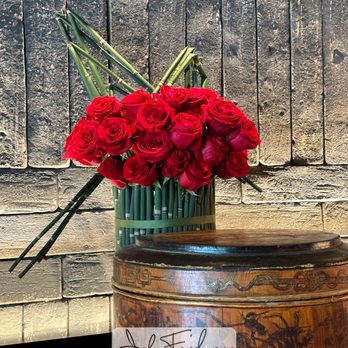 John Friedman Flowers - Modern rose arrangement featuring premium red roses with architectural greens.  Signature floral design by John Friedman Flowers, Houston. - Florists Near Me - Houston, Texas