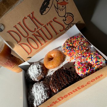 Duck Donuts - Boardwalk, cookies and cream, glazed, and rainbow sprinkles, iced caramel macchiato. - Donuts Near Me - Irvine, California Duck Donuts - Boardwalk, cookies and cream, glazed, and rainbow sprinkles, iced caramel macchiato. - Donuts Near Me - Irvine, California