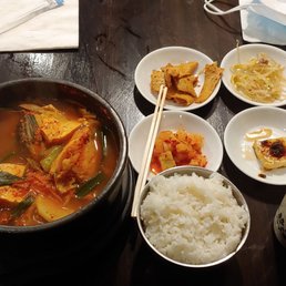 Daegu Tang (cod, seafood, tofu, and veggies spicy stew), banchan (radish, fish cake, bean sprouts, tofu), white rice, and hot barley tea