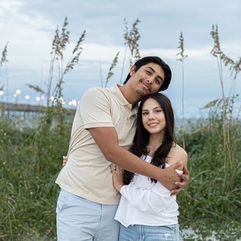 Ocean Isle Beach Photography - couple photo in the sand dunes with boardwalk and ocean in background - Session Photography Near Me - Ocean Isle Beach, North Carolina Ocean Isle Beach Photography - couple photo in the sand dunes with boardwalk and ocean in background - Session Photography Near Me - Ocean Isle Beach, North Carolina