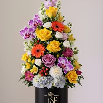 Sweet Petals - A beautiful Christmas flower tree arrangement, blending fresh blooms with festive greenery to create a warm and joyful holiday display. - Floral Designers Near Me - Brooklyn, New York Sweet Petals - A beautiful Christmas flower tree arrangement, blending fresh blooms with festive greenery to create a warm and joyful holiday display. - Floral Designers Near Me - Brooklyn, New York