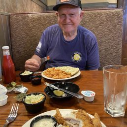 Husband enjoying nice platter of popcorn shrimp.