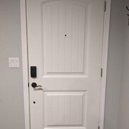 a white door with a black handle