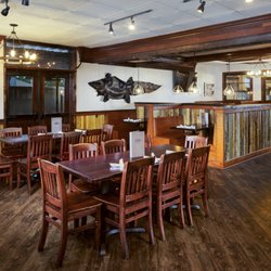 Dons Seafood- Hammond - Dining room at Don's Seafood in Hammond with alligator mount, vintage fisherman photo, and open view to the bar