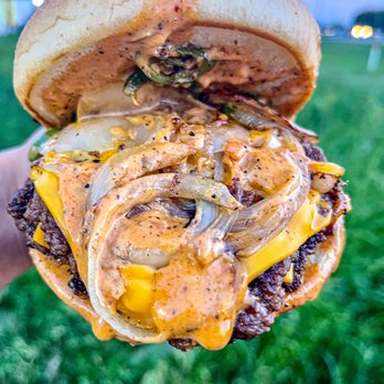 BBuddies - a hand holding a hamburger with onions and cheese - Sandwiches Near Me - Sugar Land, Texas