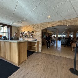 Wildberry Pancakes and Cafe - Reception desk and entrance to the big and vibrant dining room.
