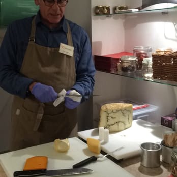 Queijaria - the owner giving us a little taste of his wonders :) - Cheese Shops Near Me - Lisbon, 11