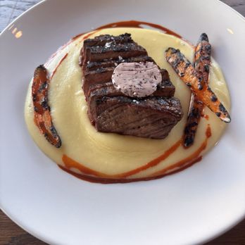 Farmers Grain Kitchen + Cellar - Strip with potato puree, roasted carrots, and carrot reduction - New American Near Me - Edmond, Oklahoma Farmers Grain Kitchen + Cellar - Strip with potato puree, roasted carrots, and carrot reduction - New American Near Me - Edmond, Oklahoma