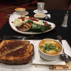 The R - "Grown-up grilled cheese" with tomato-basil soup in front; Caesar salad with grilled salmon behind.
