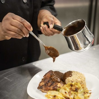 Cocoa Chili Restaurant & Catering - Putting the finishing touches on our authentic Jamaican Jerk Chicken meal. - Food Delivery Services Near Me - Chicago, Illinois Cocoa Chili Restaurant & Catering - Putting the finishing touches on our authentic Jamaican Jerk Chicken meal. - Food Delivery Services Near Me - Chicago, Illinois