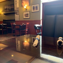 Dining room is decorated with art and photos.