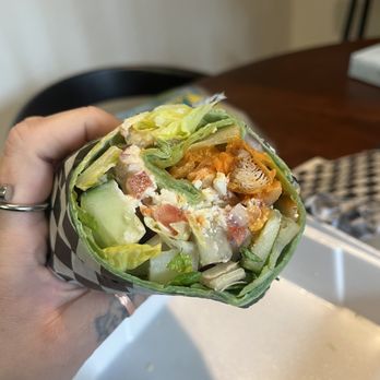 Wings Empire - a hand holding a wrap of food - Chicken Wings Near Me - Chula Vista, California Wings Empire - a hand holding a wrap of food - Chicken Wings Near Me - Chula Vista, California