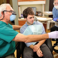 Modern Family Dentistry - Dr. James Baker explains treatment to a patient.