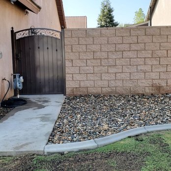 BG Landscape Services - Split faced block wall with iron gate and sidewalk to backyard pool Deck - Landscaping Near Me BG Landscape Services - Split faced block wall with iron gate and sidewalk to backyard pool Deck - Landscaping Near Me