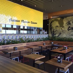 Guzman y Gomez - Seating and eating area behind store front