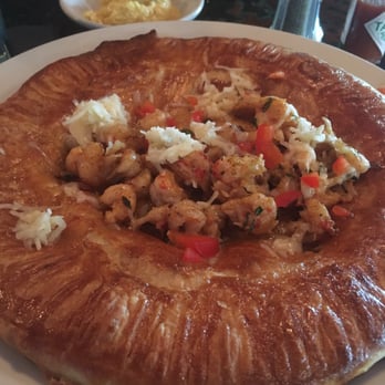 Bon Temps Grill - Crawfish Pot Pie with sautéed crawfish on top. Jalapeño Cheese grits as side. - Cajun/Creole Near Me - Lafayette, Louisiana Bon Temps Grill - Crawfish Pot Pie with sautéed crawfish on top. Jalapeño Cheese grits as side. - Cajun/Creole Near Me - Lafayette, Louisiana