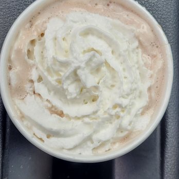 The Human Bean - Hot Chocolate/cocoa - A cup of hot chocolate with whipped cream on top, placed on a black tray. - Coffee & Tea Near Me - Albuquerque, New Mexico