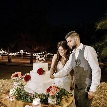 Candice Rose Events & Design - Wrapped lights around the corral for after sunset. Rented the barrel with top and decorated our plain white wedding cake - Party & Event Planning Near Me