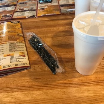 9er's Grill - a table with two cups of coffee and a menu - American Near Me - Montgomery, Illinois