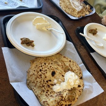 AJA Catering - a table with plates of food - Indian Near Me - Guadalupe, Arizona