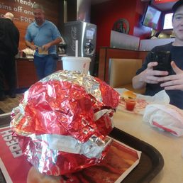 The T-Rex burger wrapped up, and out of its wrapper.