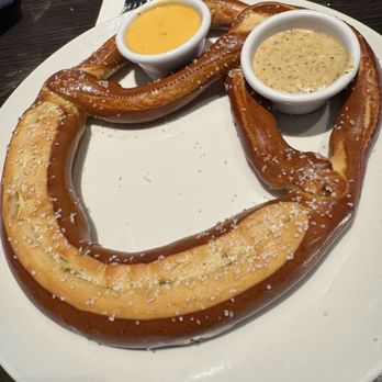 Miller's Ale House - Hot pretzel with cheese and a mustard dipping sauce. - Sports Bars Near Me - Ocala, Florida