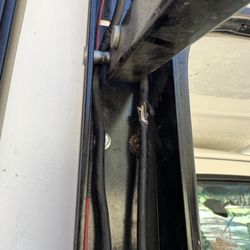 Rhondas RV Rentals - Existing condition and wear of the awning assembly, including exposed wiring and visible deterioration around the mechanism.