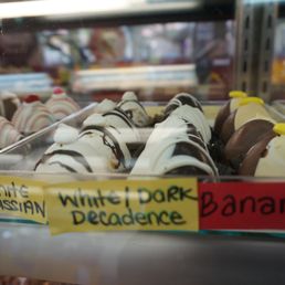 a variety of donuts in a display case