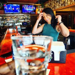 a woman sitting at a bar a woman sitting at a bar