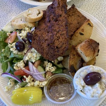 Voula's Greek Sweets - Vegan combo plate with salad, lemon potatoes, and their house-made seitan gyro. - Desserts Near Me - Rochester, New York Voula's Greek Sweets - Vegan combo plate with salad, lemon potatoes, and their house-made seitan gyro. - Desserts Near Me - Rochester, New York