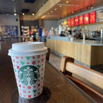 Starbucks - a starbucks cup sitting on a table - Coffee & Tea Near Me - Tampa, Florida Starbucks - a starbucks cup sitting on a table - Coffee & Tea Near Me - Tampa, Florida