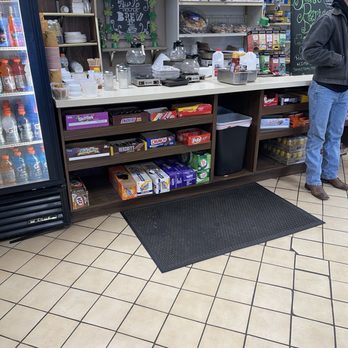 New Country Deli - a man standing in front of a refridgerator - Delis Near Me - Syosset, New York New Country Deli - a man standing in front of a refridgerator - Delis Near Me - Syosset, New York