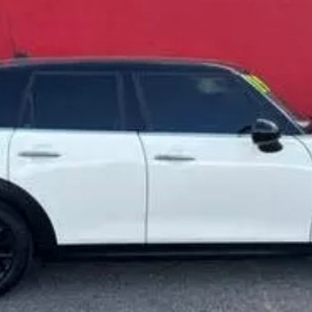 Car Pros Auto Sales - A white compact SUV with tinted windows and black wheels is parked in front of a red wall, with a yellow sticker on the windshield. - Car Dealers Near Me - Albuquerque, New Mexico