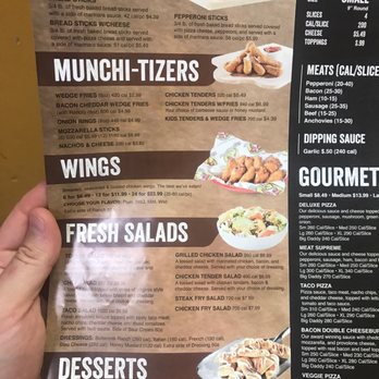Fox's Pizza Den - a hand holding a menu - Pizza Near Me - Front Royal, Virginia