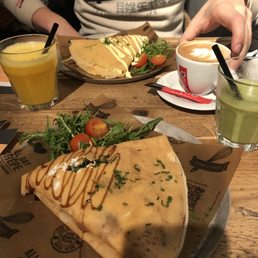 Savoury crêpes with smoothie, juice, and coffee.