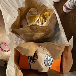 two brown paper bags with food in them