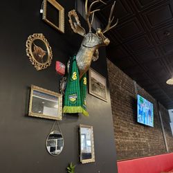 Pizza Beer Whiskey - The bronze bust of the deer - note the glasses and pipe, and DKCU Soccer Scarf! Awesome!