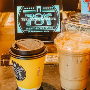 787 Coffee - The cups of coffee. A regular oatmilk latte, and a coquito iced latte to the right. - Coffee & Tea Near Me - New York, New York 787 Coffee - The cups of coffee. A regular oatmilk latte, and a coquito iced latte to the right. - Coffee & Tea Near Me - New York, New York