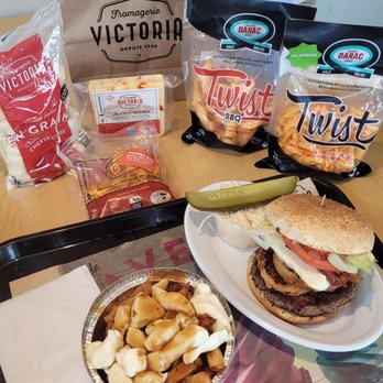 Fromagerie Victoria - a sandwich, chips, and a pickle on a tray - Poutineries Near Me - Saint-Jérôme, Quebec Fromagerie Victoria - a sandwich, chips, and a pickle on a tray - Poutineries Near Me - Saint-Jérôme, Quebec