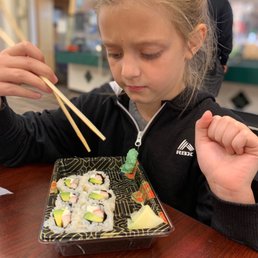 She wasn't happy about the wasabi but enjoyed her Philly crab roll