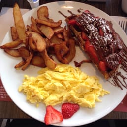 Half a waffle with strawberries and Nutella (without the English Creme) and scrambled eggs with home fries. Half a waffle with strawberries and Nutella (without the English Creme) and scrambled eggs with home fries.