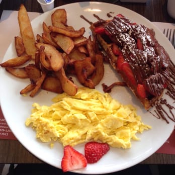 Petinos - Half a waffle with strawberries and Nutella (without the English Creme) and scrambled eggs with home fries. - Breakfast & Brunch Near Me - Laval, Quebec Petinos - Half a waffle with strawberries and Nutella (without the English Creme) and scrambled eggs with home fries. - Breakfast & Brunch Near Me - Laval, Quebec