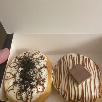 Happy Donuts - On the left is an Oreo donut and on the right is a chocolate caramel donut. - Donuts Near Me - London, XGL
