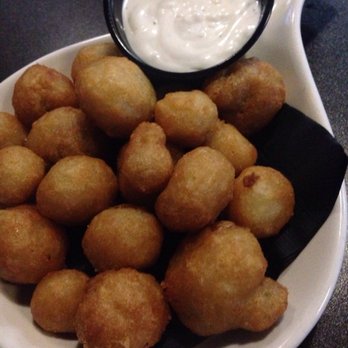 Twisted Arm - a plate of fried tater tots with a dipping sauce - Bars Near Me - Sarnia, Ontario Twisted Arm - a plate of fried tater tots with a dipping sauce - Bars Near Me - Sarnia, Ontario