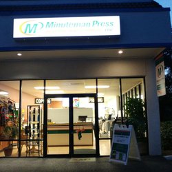 Minuteman Press - The storefront at night.