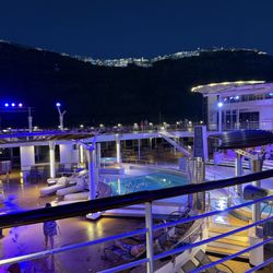 Revitalize Vacations - The Celebrity Cruise ship with the Greek island in the background.
