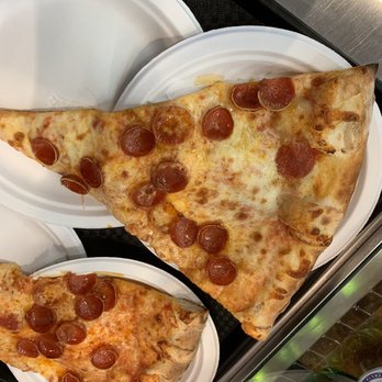 Pizza Ponte - "Very" large pepperoni pizza slice that dwarfs the dinner plate - Italian Near Me - Lake Buena Vista, Florida Pizza Ponte - "Very" large pepperoni pizza slice that dwarfs the dinner plate - Italian Near Me - Lake Buena Vista, Florida